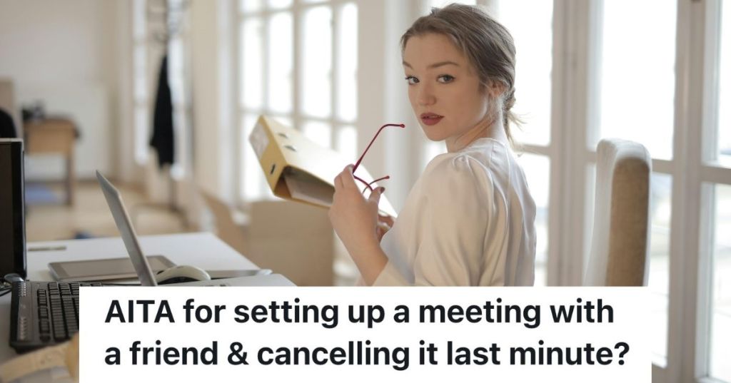 Woman posing with glasses and a binder at a desk