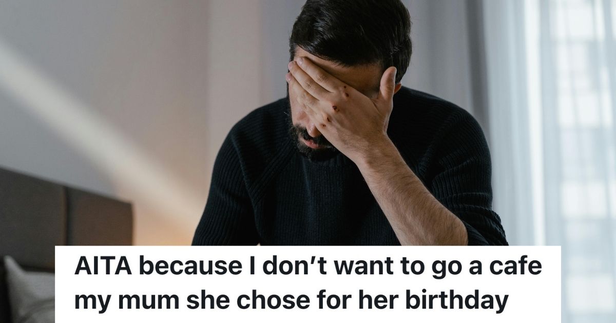 Man sitting on bed with his head in his hand