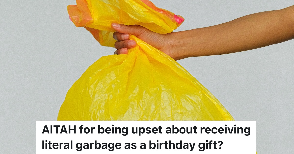 hand holding out a yellow garbage bag