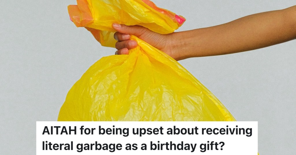 hand holding out a yellow garbage bag