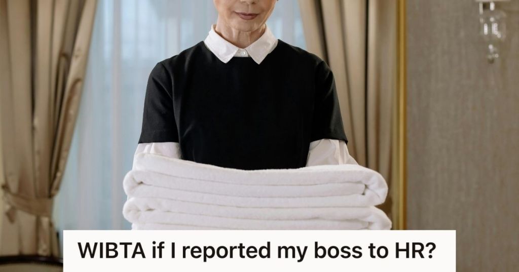 housekeeper holding a stack of towels