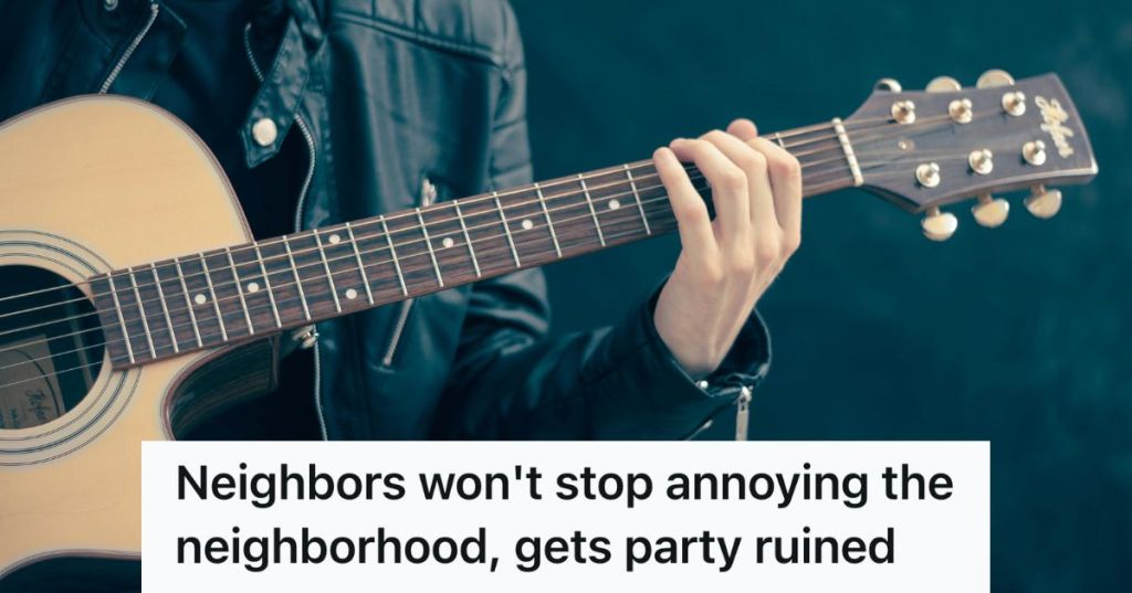 man strumming an acoustic guitar