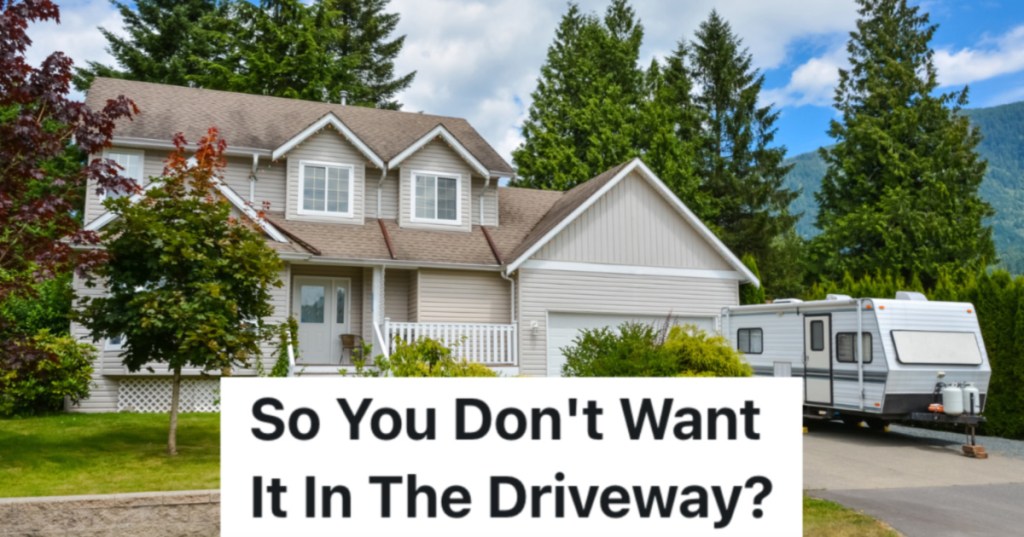 RV parked in driveway of 2-story house
