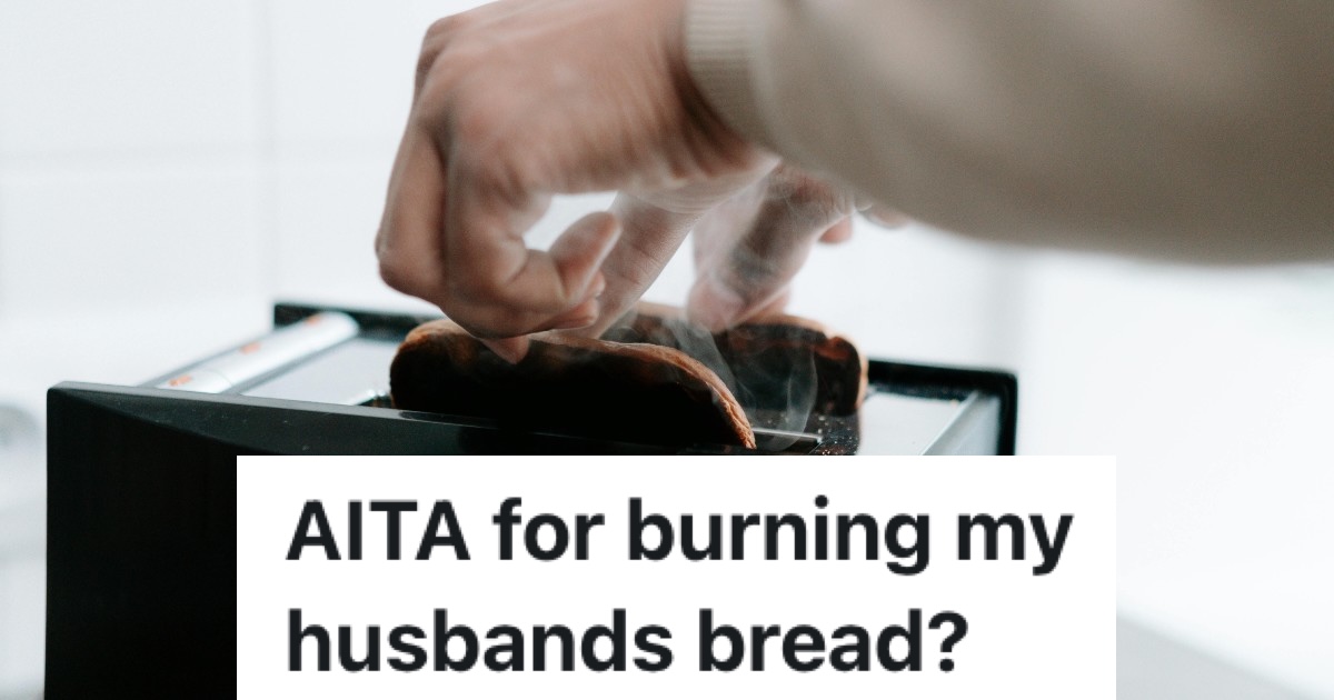 person pulling burned toast from toaster