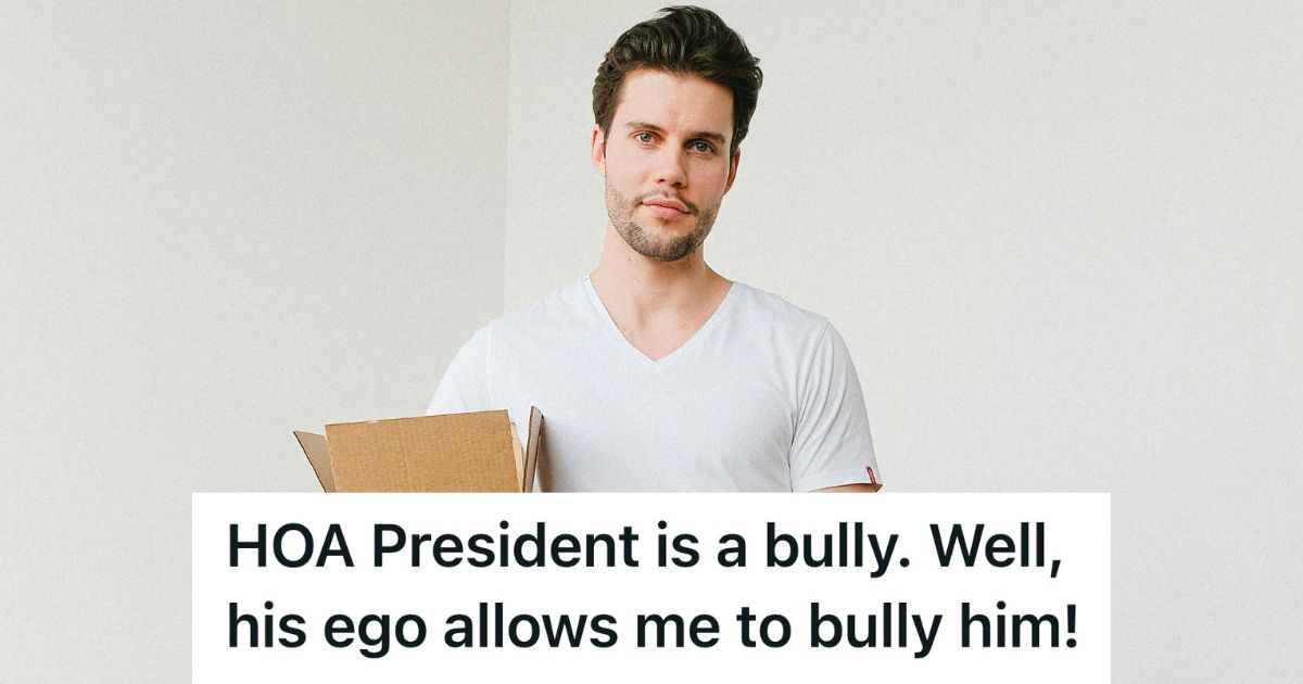 smiling man in white shirt holding moving box