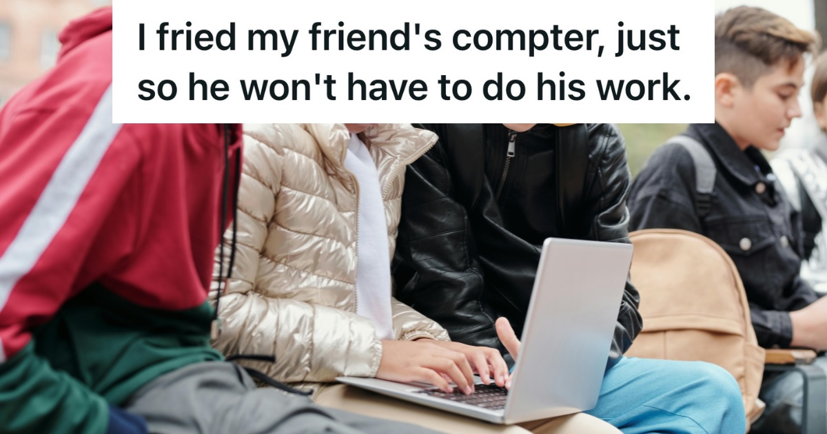 students gathered around a laptop