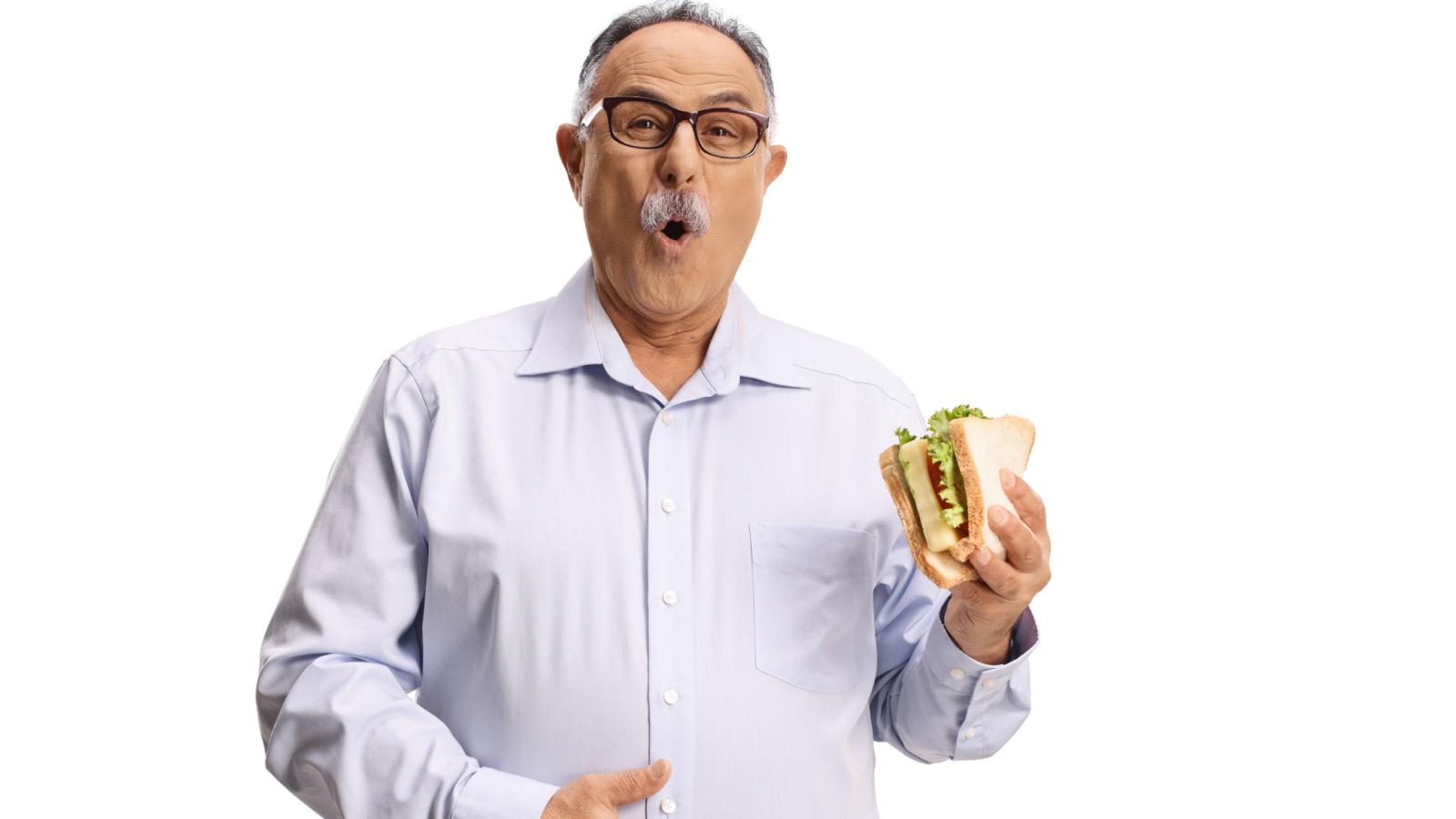 He Made Lunch for His Abusive Father and Drew Mustard Pranks on the Sandwiches, Only to Learn His Mom Was Doing the Same Thing man holding a sandwich