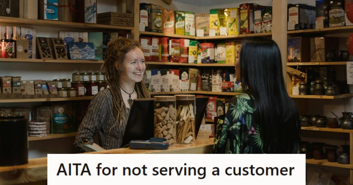 Cashier standing behind a register smiling at a customer