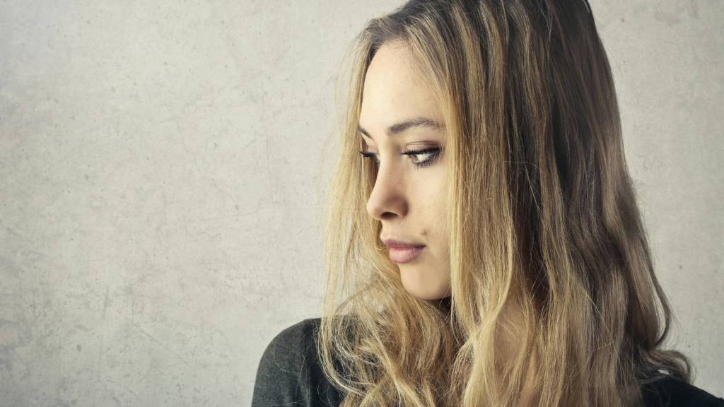 Woman thinking because her sister is upset with her