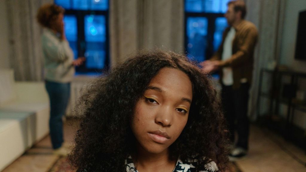 upset teen girl parents arguing