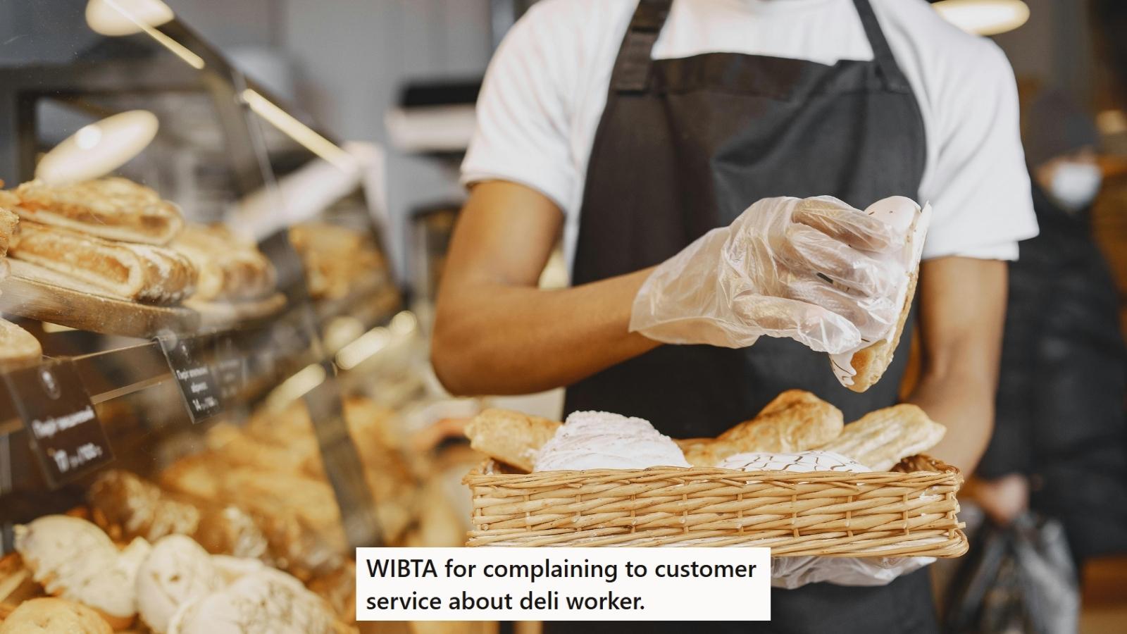 Man working at a deli wearing gloves and handling food