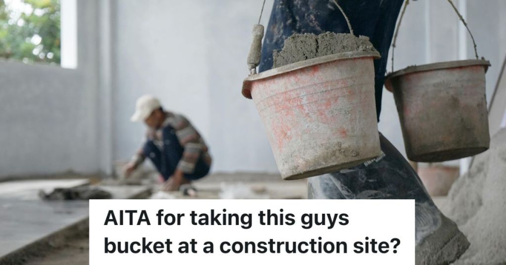 man carrying two buckets on a construction site