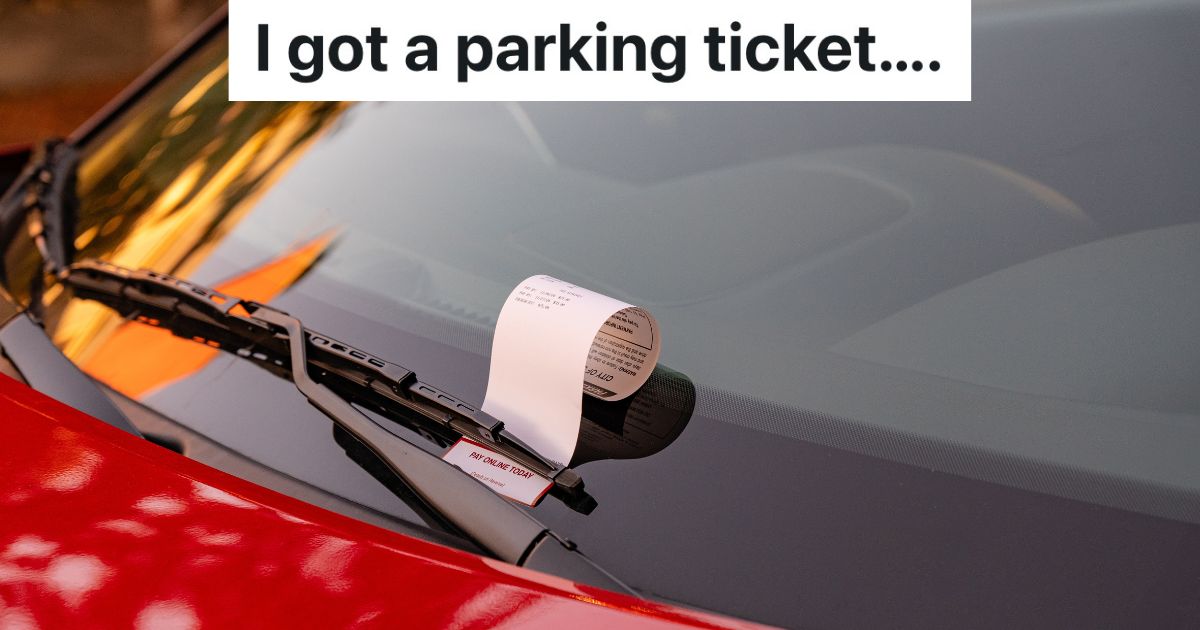 parking ticket on windshield of red car