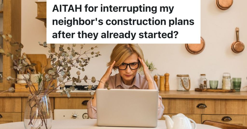 upset woman looking at computer in her kitchen