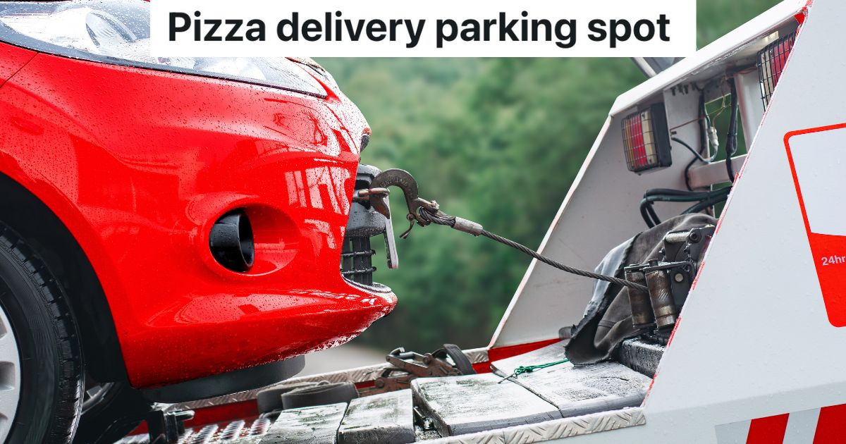 closeup of red car hooked up to tow truck