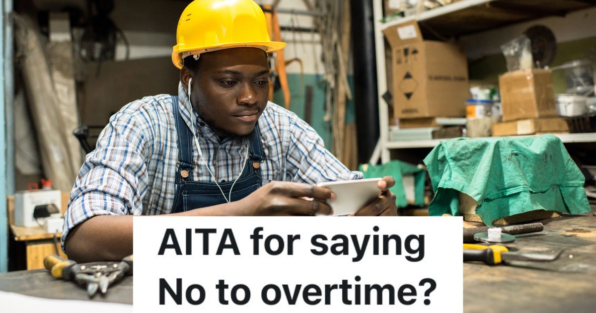 man in a hardhat looking at his phone