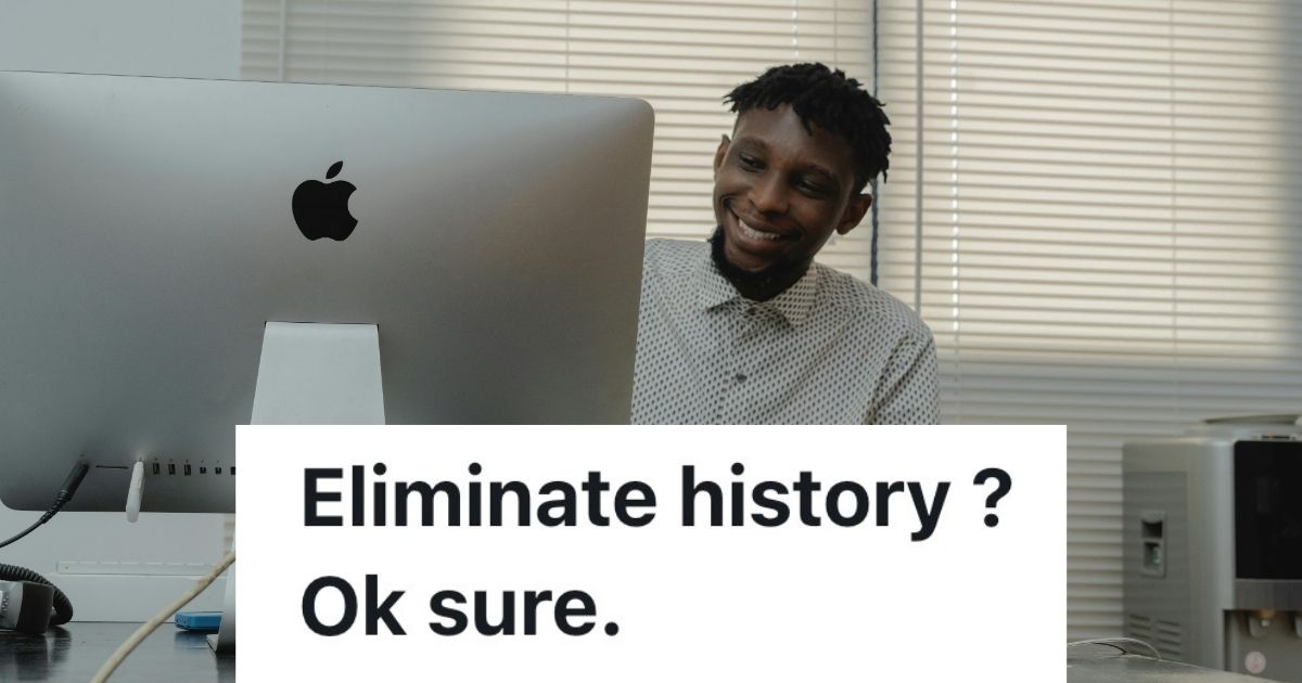 Man smiling at computer in office