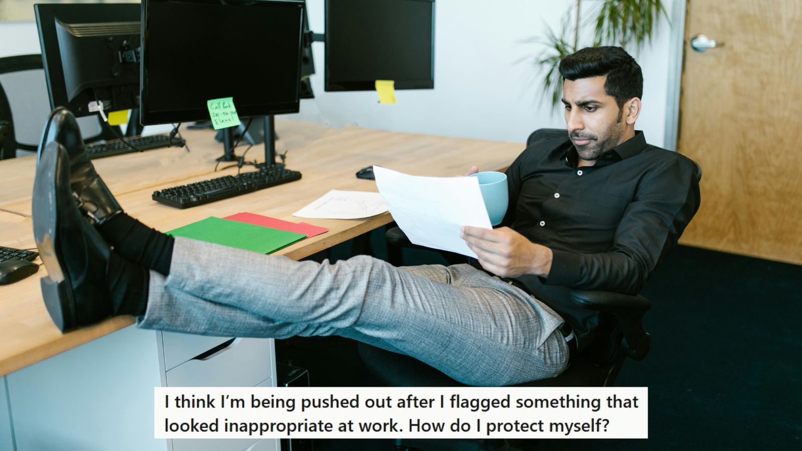 Man in black working in office