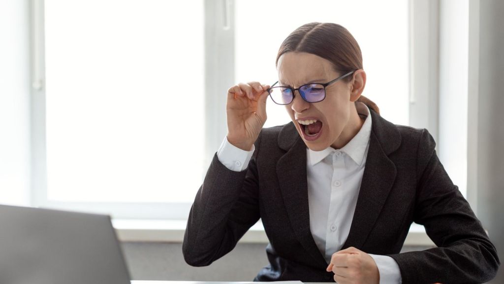 woman screaming at a laptop