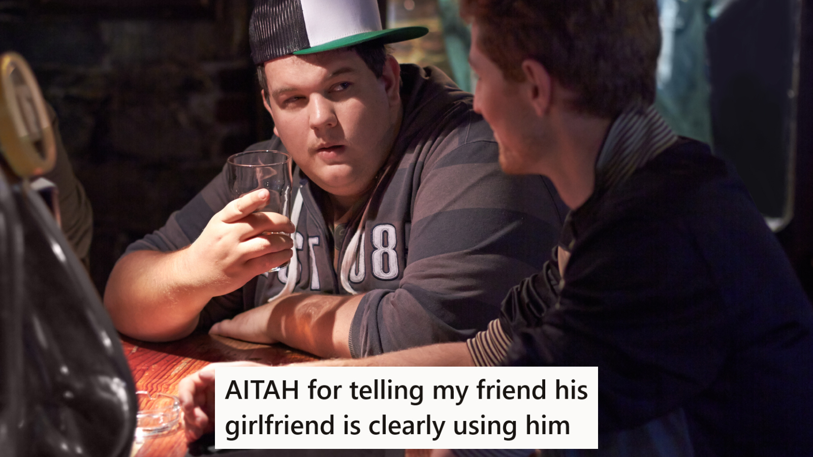 Two men talking at a bar