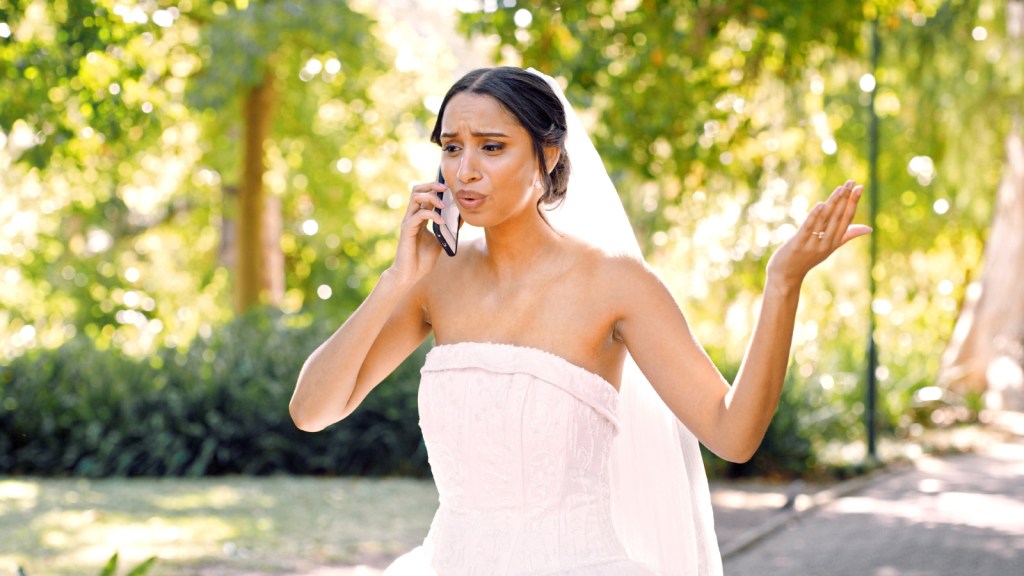 A bride looking frustrated while on the phone