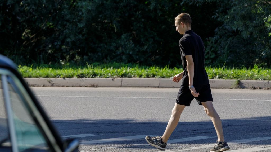car waiting for pedestrian to cross