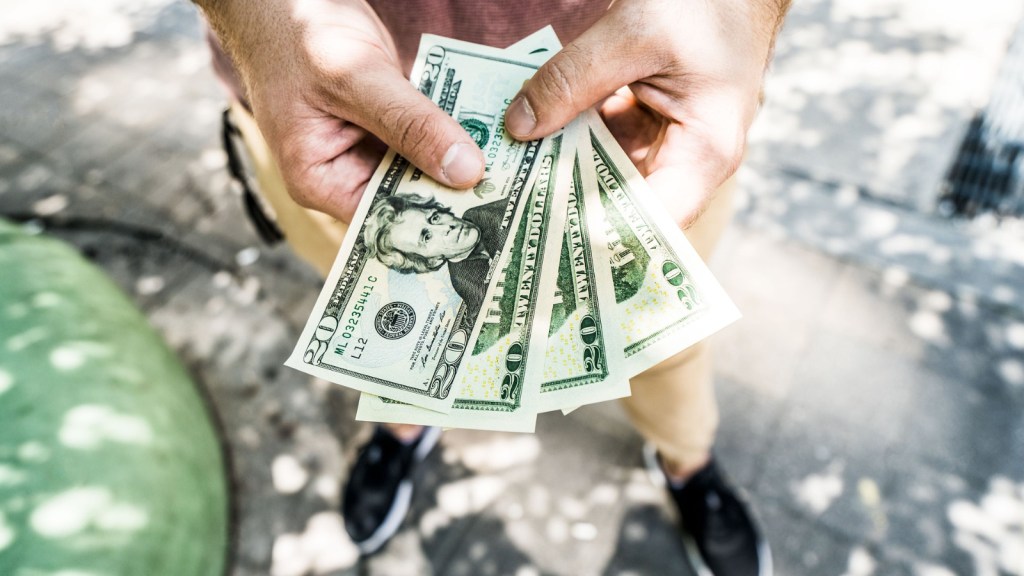 A person holding cash