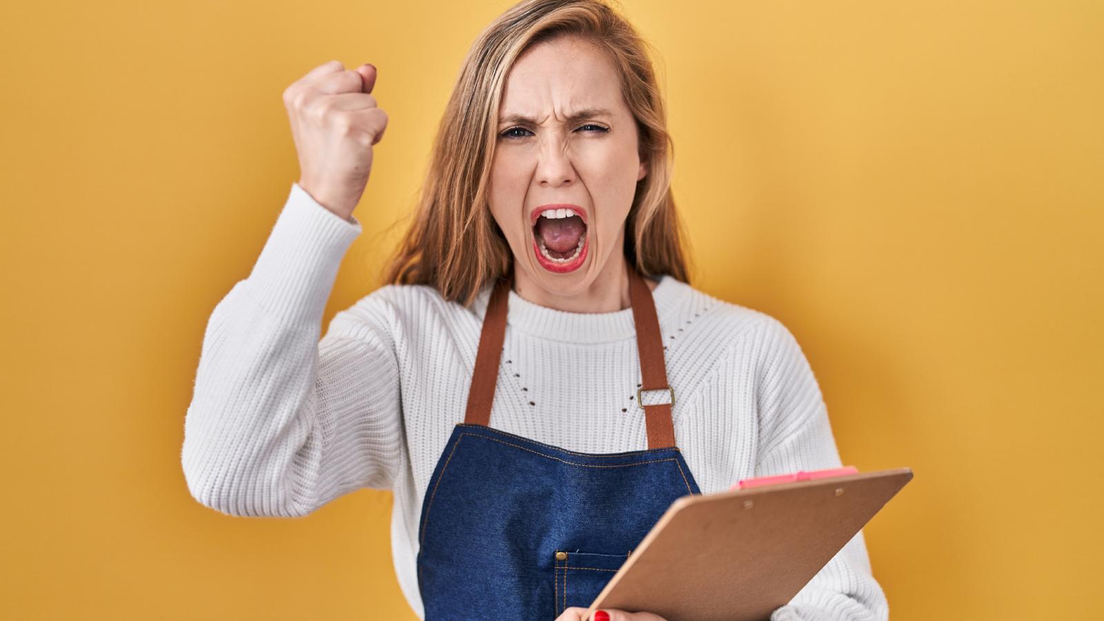 Two Angry Restaurant Tables Turned One Waitress’s Shift Into a Nightmare woman shaking her fist