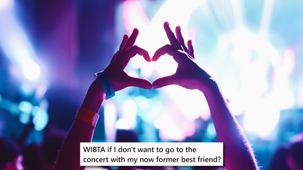 Someone makes a heart sign in a concert crowd