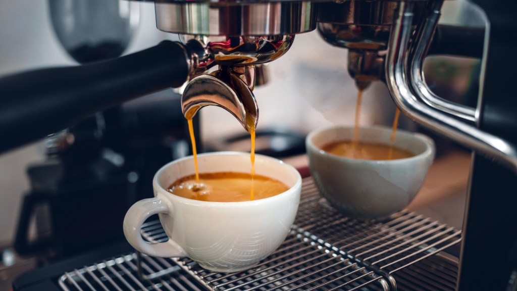 Espresso dripping into a mug