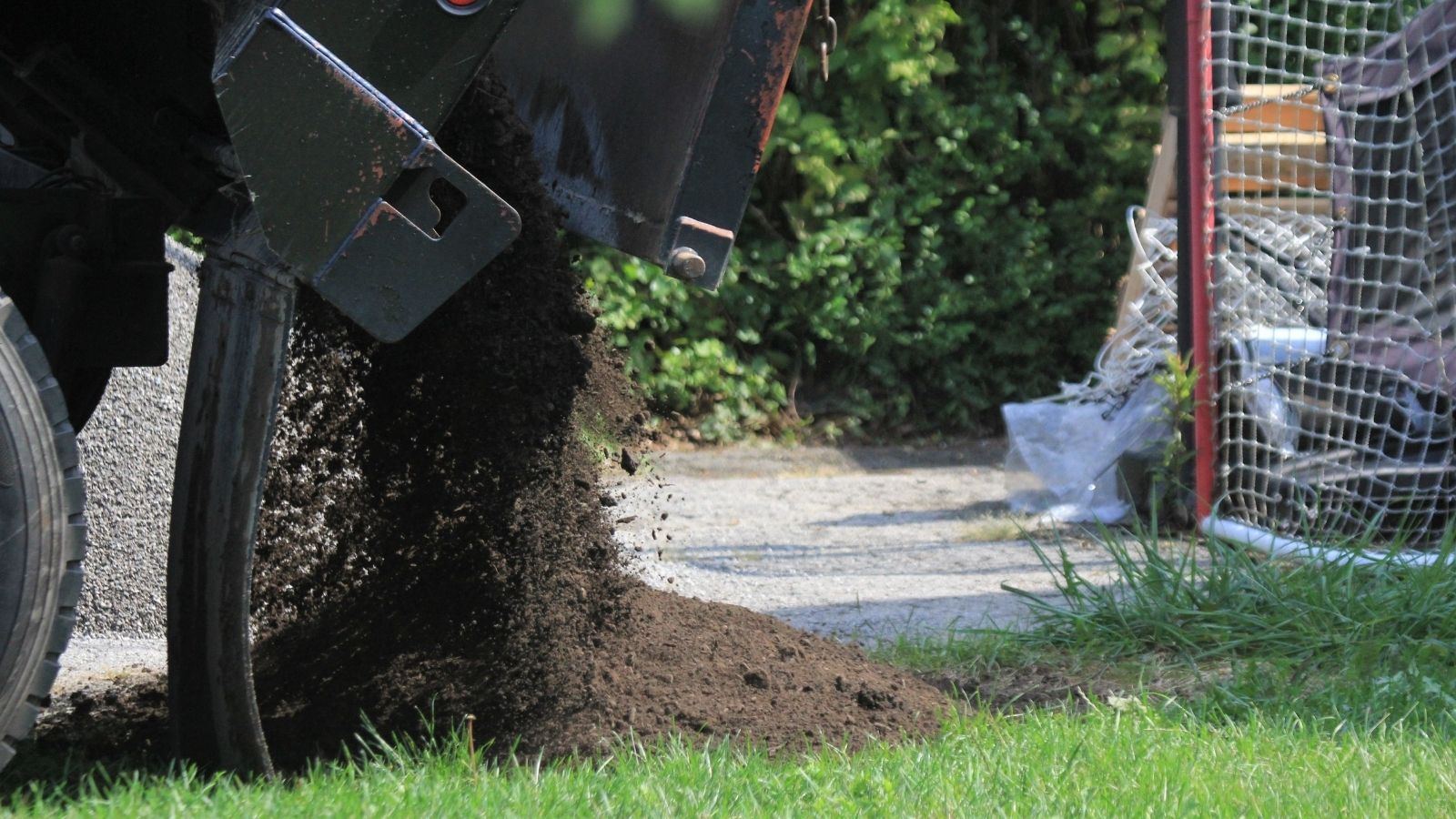 truck delivering dirt to a driveway