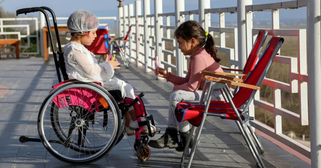 sisters, one in a wheelchair