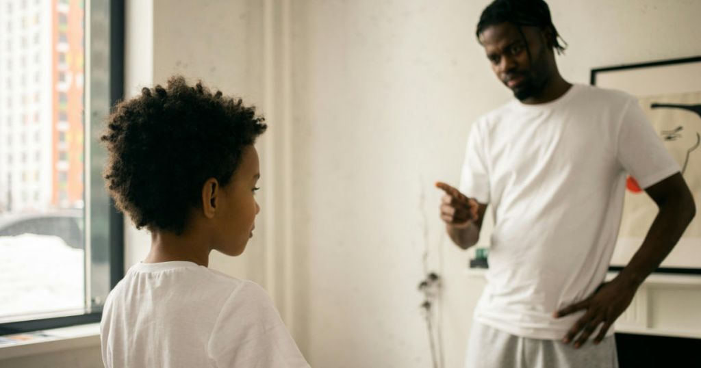 man disciplining boy