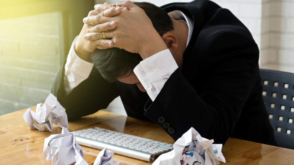 man with head down on desk