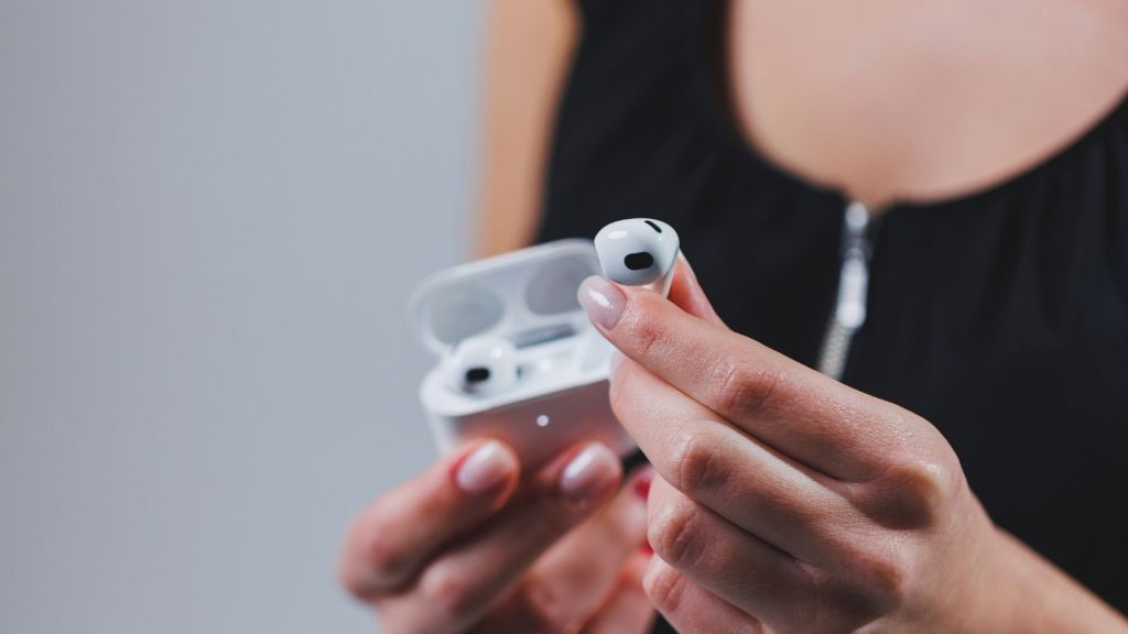 woman holding up an air pod