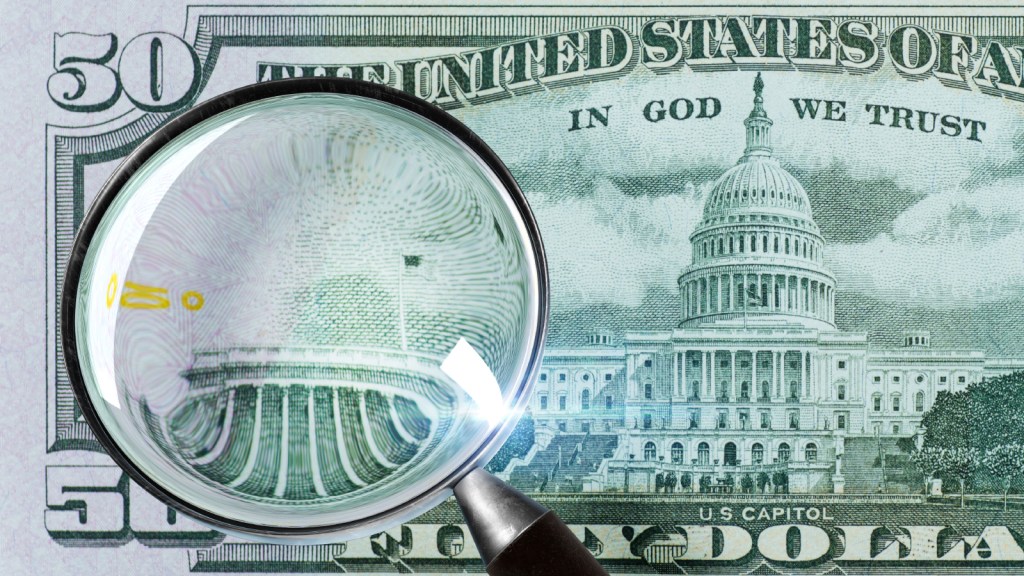 A $50 bill with a magnifying glass over it