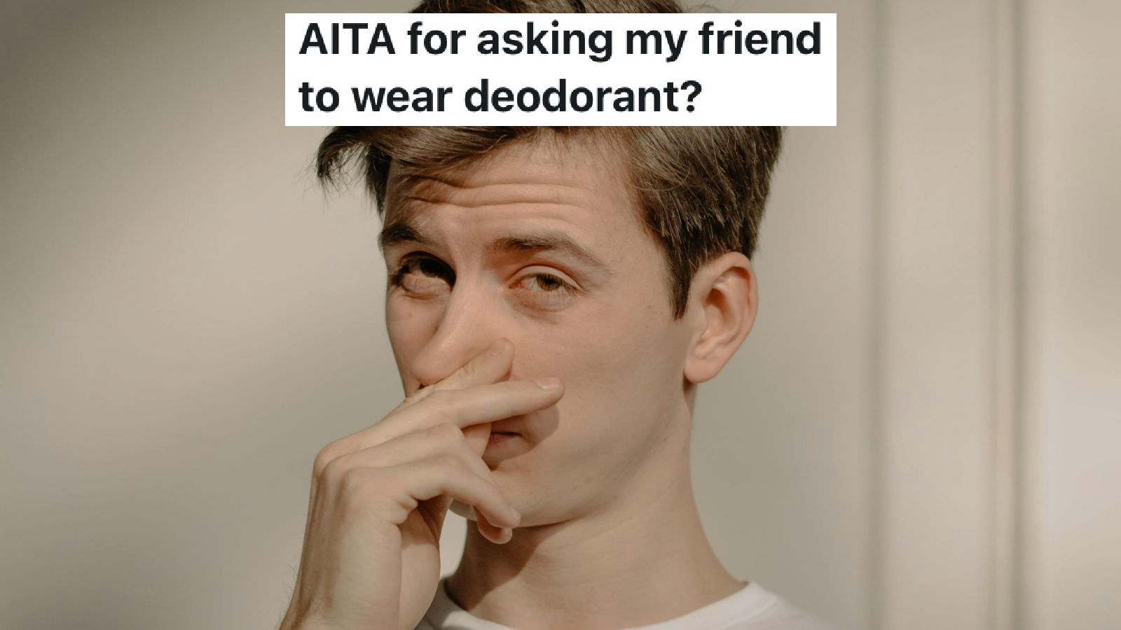 man holding his nose