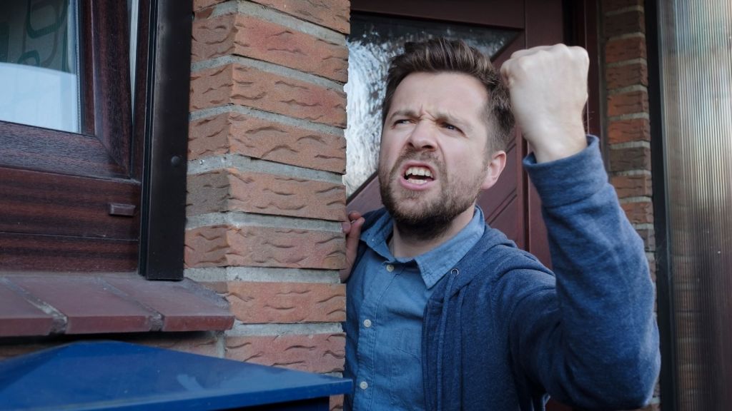 man yelling out his front door