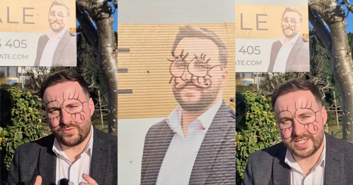 man in front of a poster
