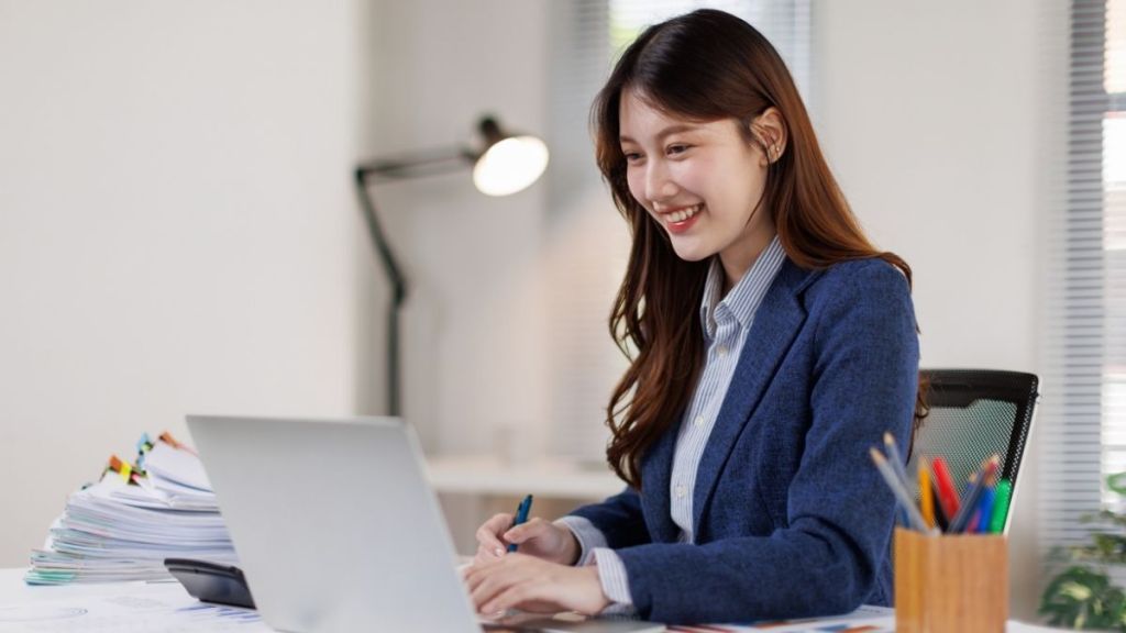 woman smiling at her laptop