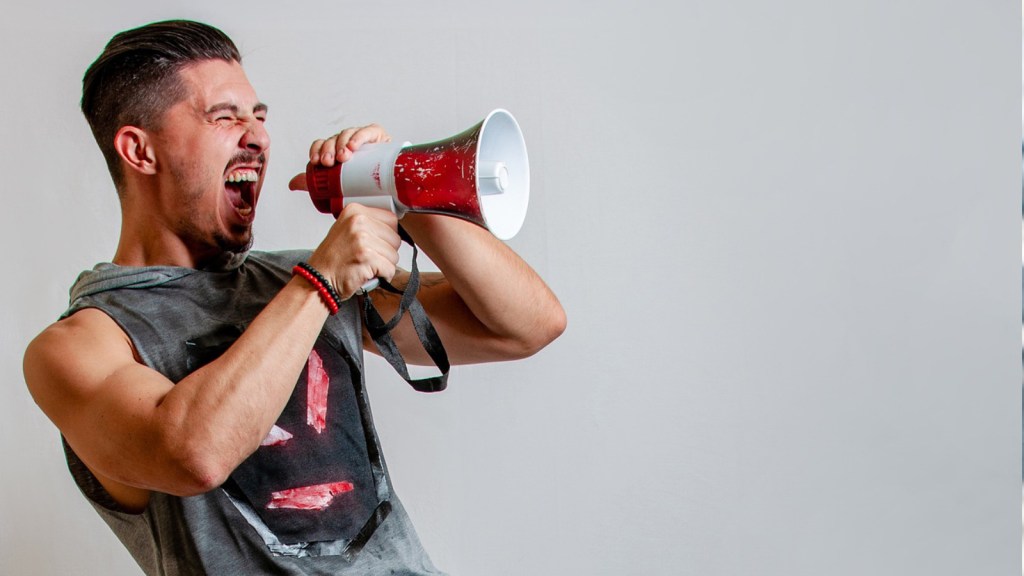 A man shouting into a megaphone