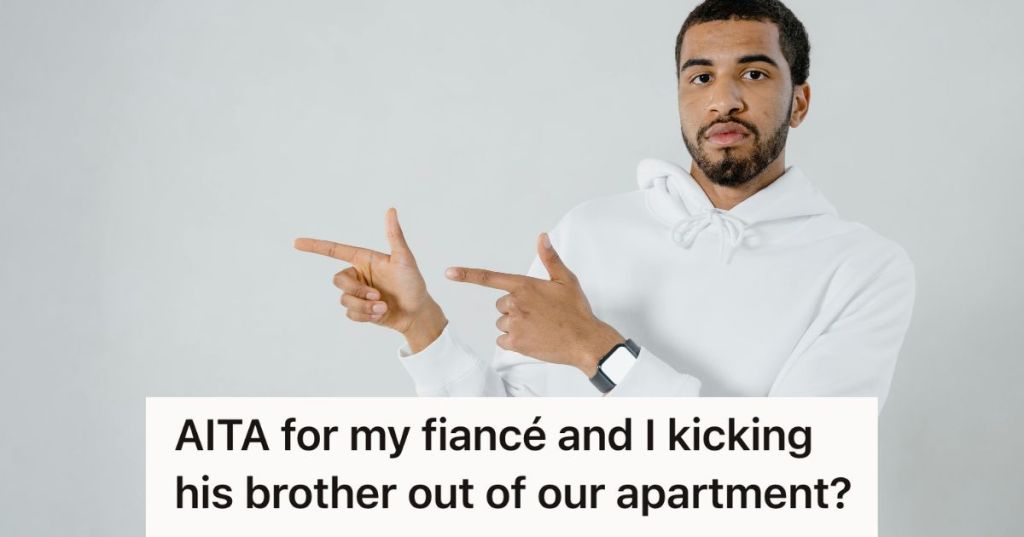 man in white hoodie pointing