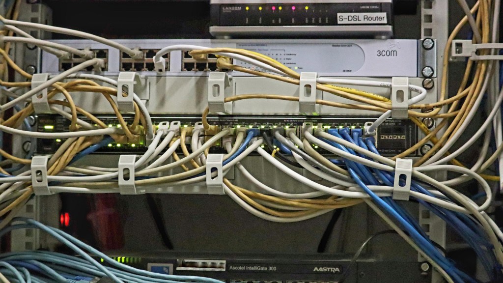 A tangled mess of wires on a server rack