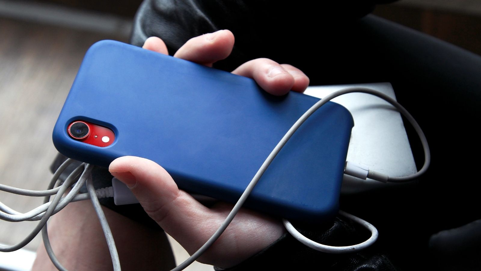 person holding phone being charged