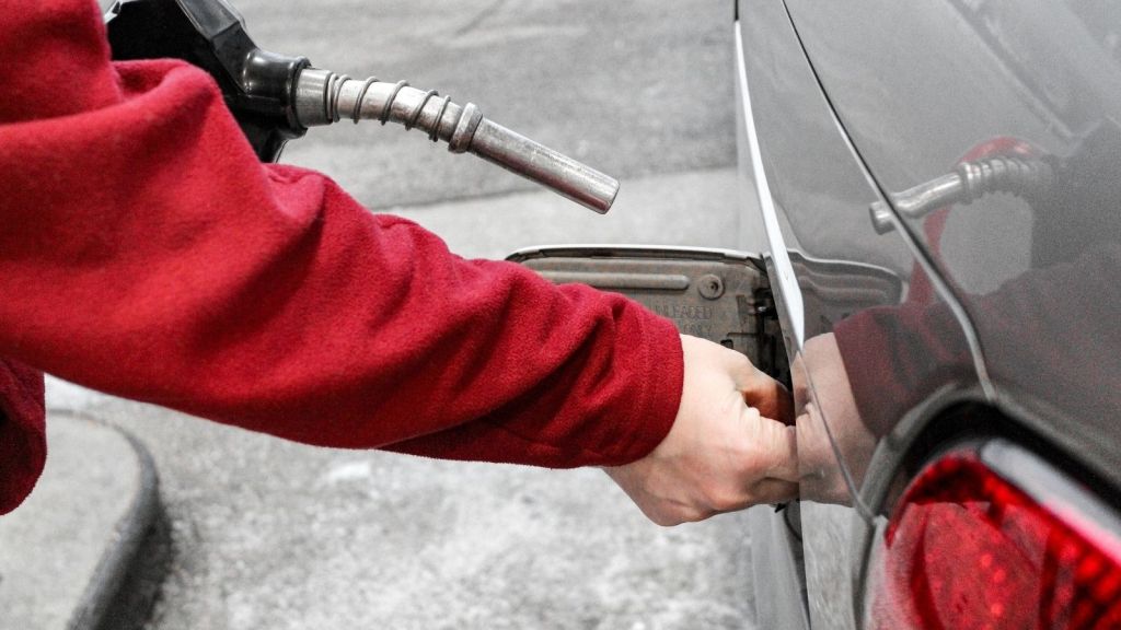 person pumping gas
