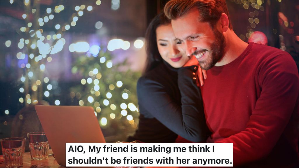 man and woman smiling at a laptop