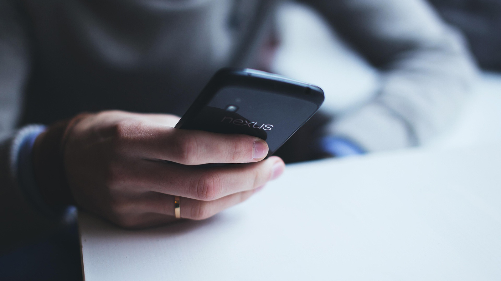 A hand holding a smart phone