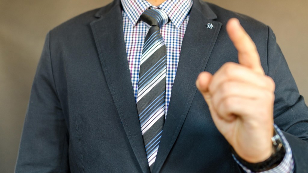A man in a suit wagging a finger