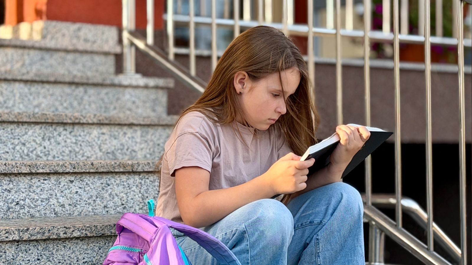A young girl reading a book