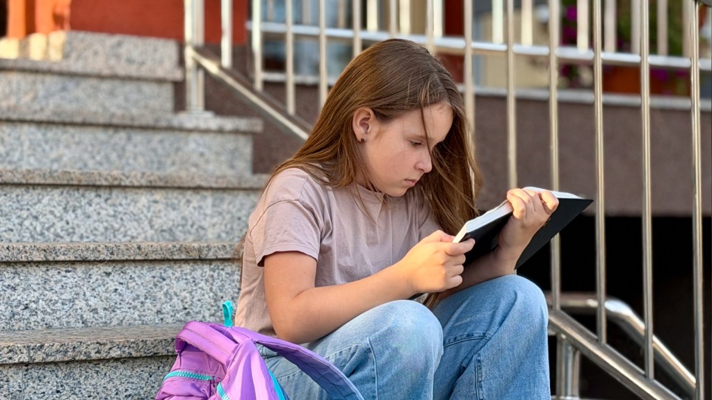 A young girl reading a book